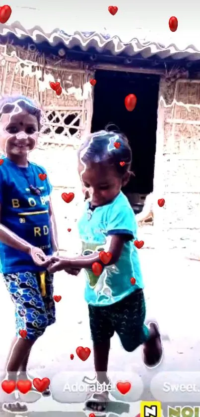 Two children smiling with red heart overlay, village background.