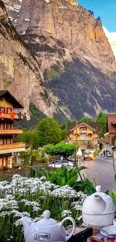 Scenic view of mountain village with flowers and cliffs.