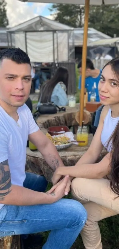 Outdoor picnic scene with two people by a table.