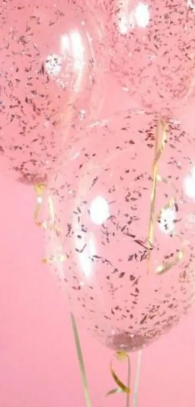 Pink wallpaper with clear balloons and gold confetti.