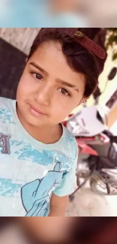 Child wearing a cap with a light blue shirt.