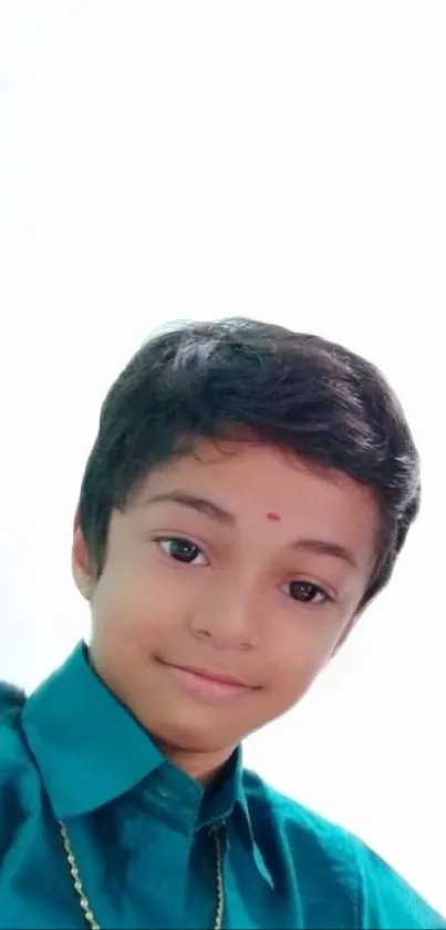 Smiling child in teal shirt with white background wallpaper.