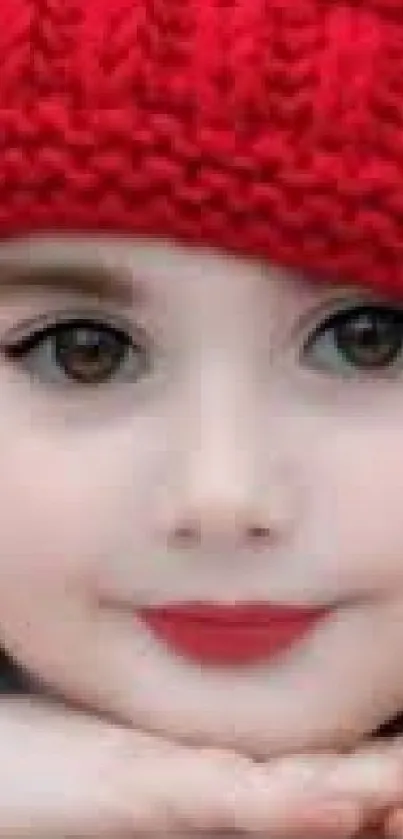 Child in a red knit hat with a gentle smile, perfect for mobile wallpaper.