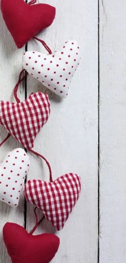 Handcrafted red and white hearts on rustic wood wallpaper.