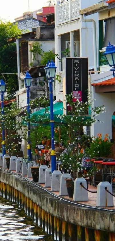 Riverside street with colorful lamps and historic architecture.