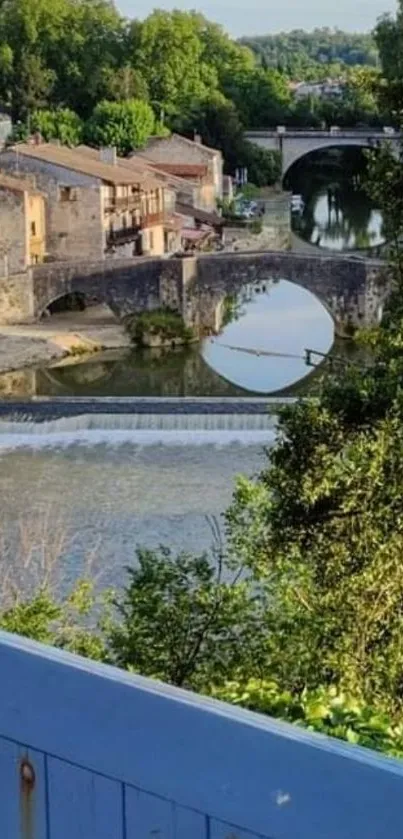 Scenic view of a picturesque village with a river and stone bridge.