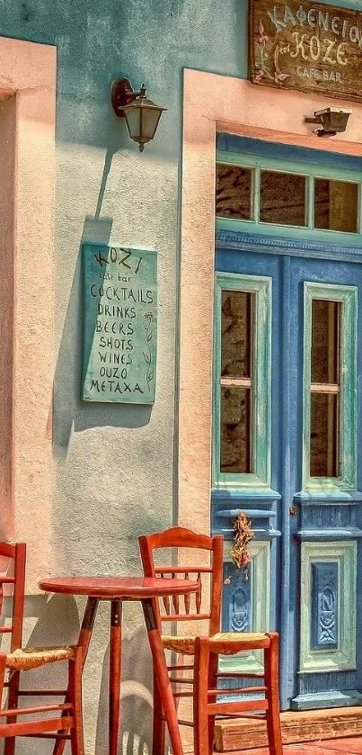 Charming blue door cafe entrance with red chairs and rustic decor.