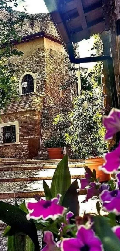 Quaint rustic courtyard with flowers and stone buildings.