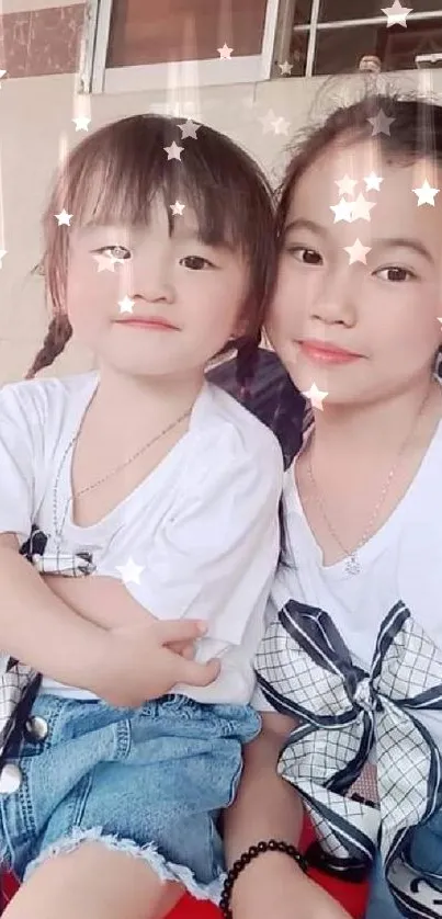 Adorable sisters in white tees with smiles in a cozy indoor setting.