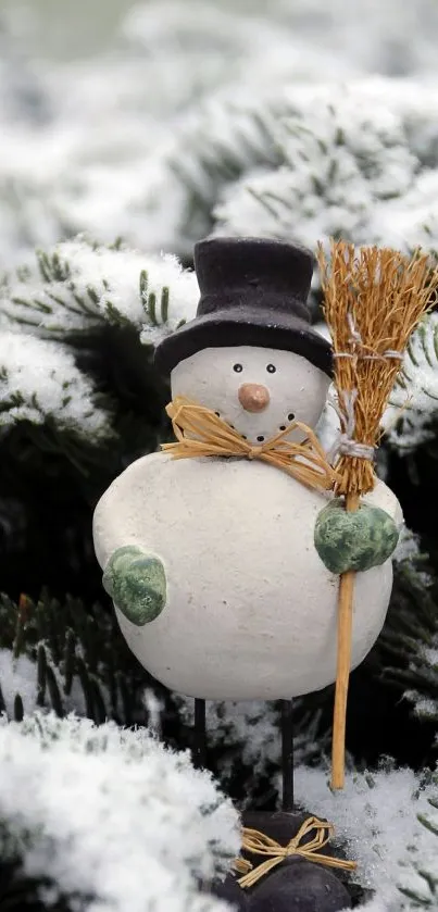 Snowman in top hat holding broom in snowy pine branches.