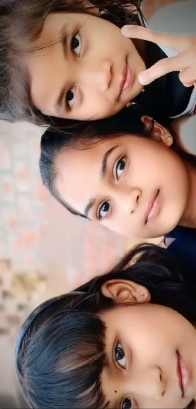 Three smiling children posing together, showcasing a charming expression.