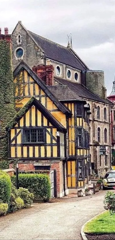 Tudor-style village with rustic buildings and lush greenery on a cloudy day.