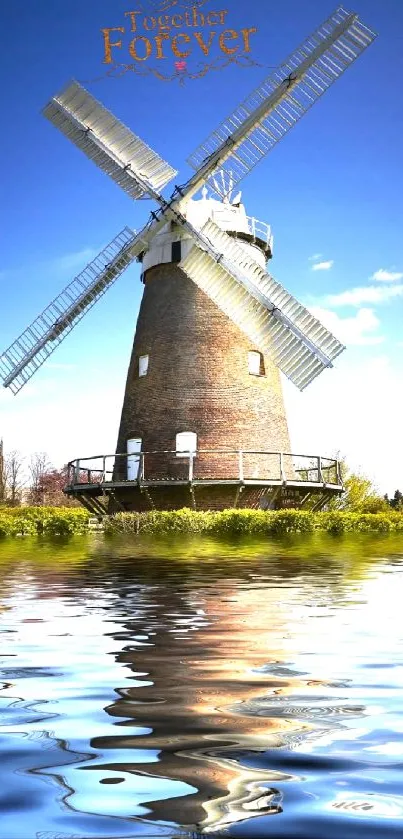 Windmill with blue sky and water reflection, serene mobile wallpaper.