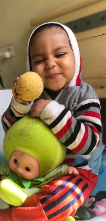 Cheerful baby holding a doll in a colorful mobile wallpaper.