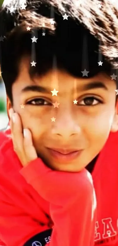 Boy in a red shirt with stars overlay, smiling vividly.