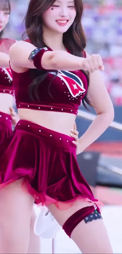 Smiling dancer in maroon costume performing energetically.