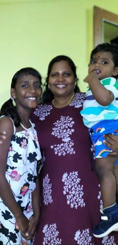 Joyful family portrait with mother and children in vibrant outfits.