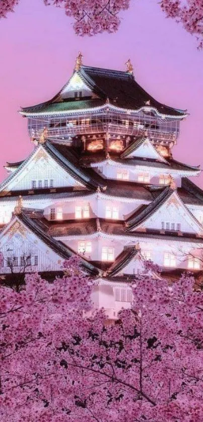 Japanese castle surrounded by cherry blossoms under a pink sky.