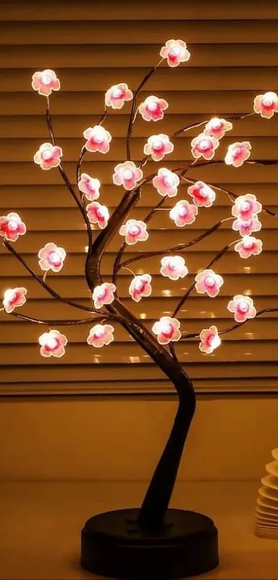 Illuminated cherry blossom lamp on table.