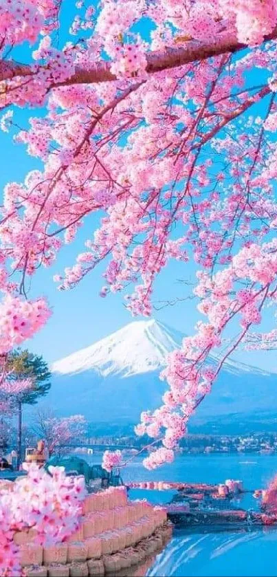 Beautiful cherry blossoms with a majestic mountain backdrop under a clear sky.