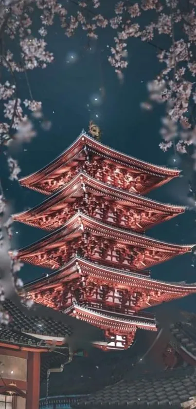 Japanese pagoda surrounded by cherry blossoms at night.