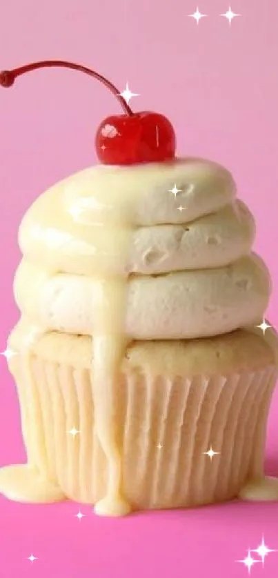 Cherry-topped cupcake with creamy frosting on a pink background.