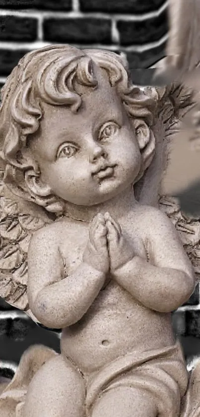 Cherubic stone angel sculpture with a brick wall backdrop.