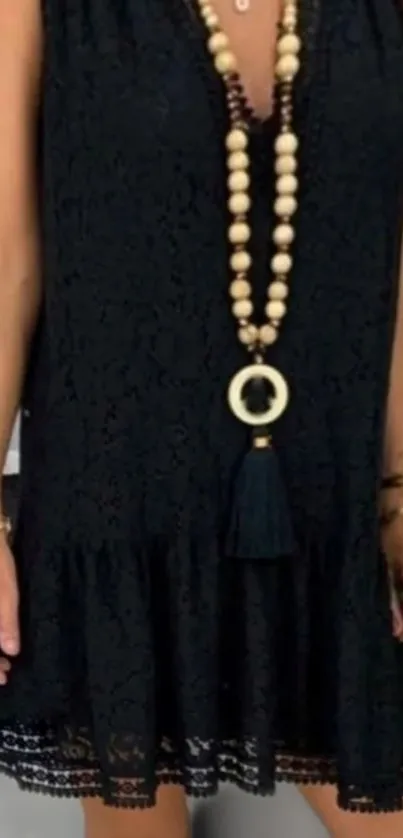 Chic black lace dress with beaded necklace.