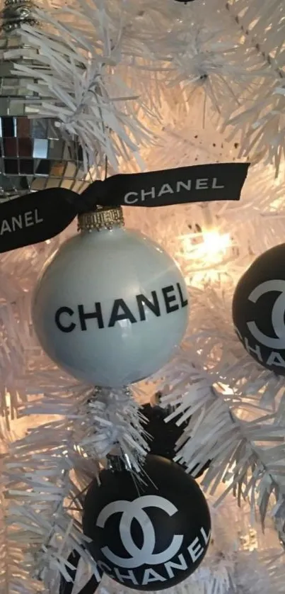 Chanel Christmas ornaments on a white festive tree with elegant design.