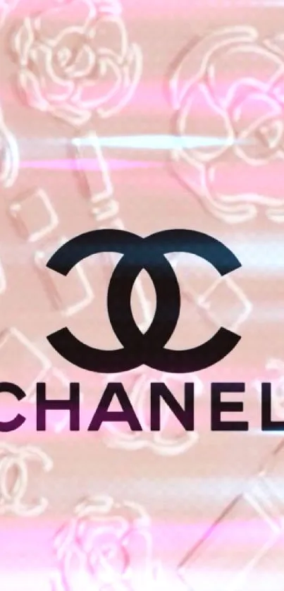 Soft pink Chanel logo mobile wallpaper with floral accents.