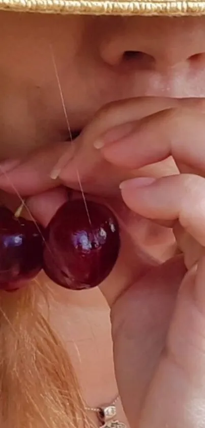 Woman with cherries and a straw hat, close-up.