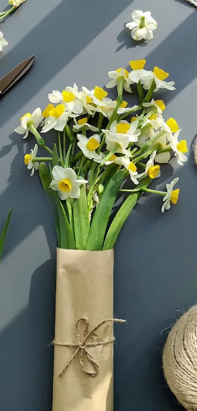 Daffodil bouquet with Kraft paper on gray background.