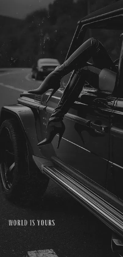 Chic legs sticking out of a luxury car in black-and-white, styled elegantly.