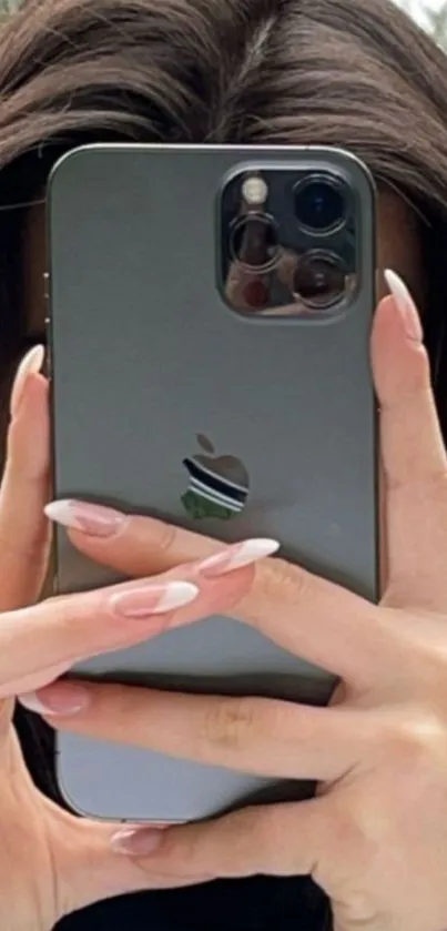 Chic smartphone held by hands with styled nails.