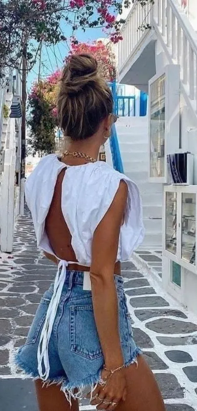 Chic woman walks down a vibrant summer street.