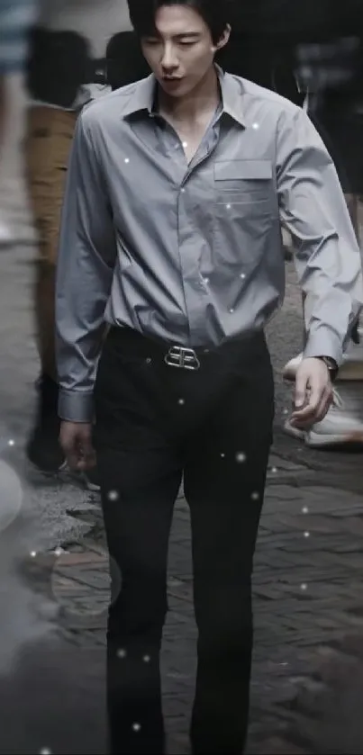 Man in a stylish gray outfit walking on an urban street.