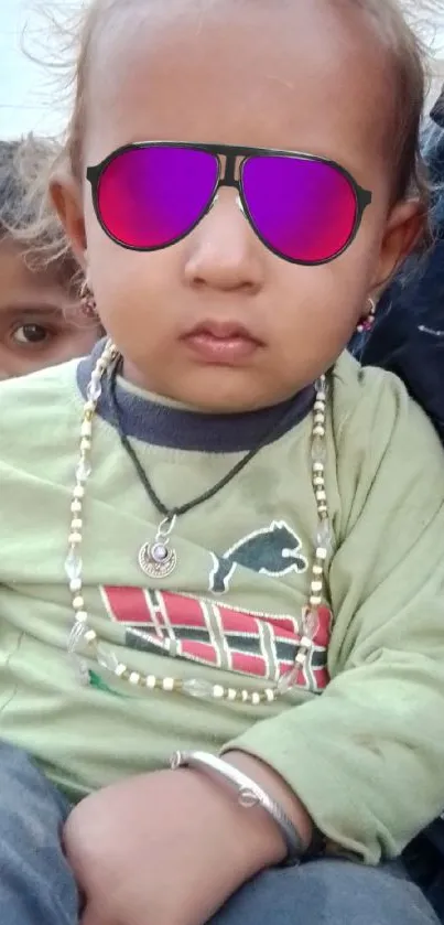 Child wearing sunglasses in a stylish outdoor setting.