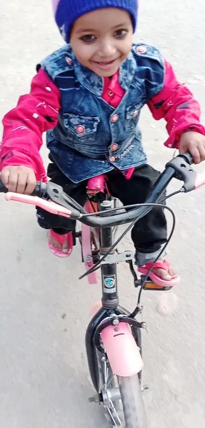 Smiling child joyfully riding a bicycle.