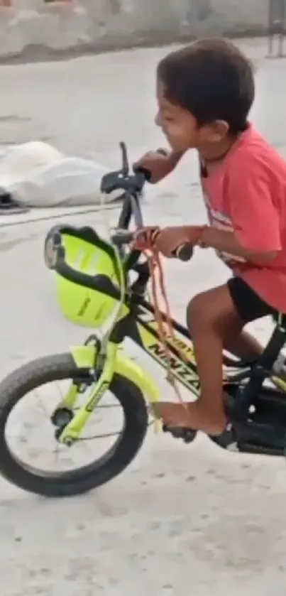 Joyful child cycling outdoors on a lime green bike.