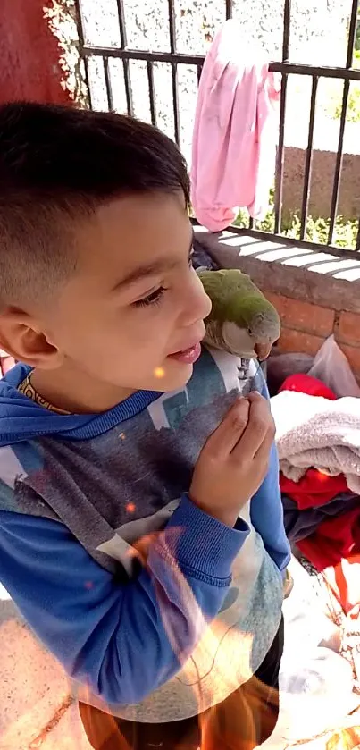 Young boy with a parrot on shoulder, outdoors, colorful scene.