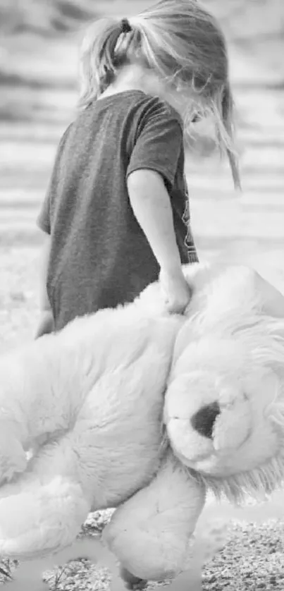 Black and white image of child holding a large teddy bear on a path.