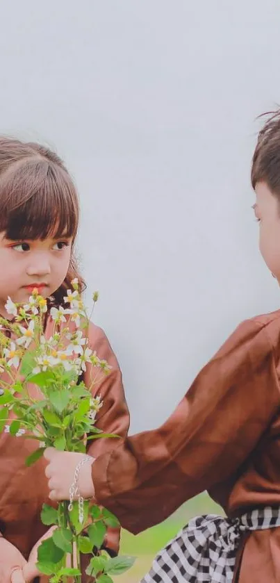 Children in brown outfits exchanging flowers.