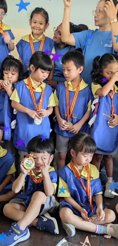 Children in blue uniforms with medals at a celebratory event.