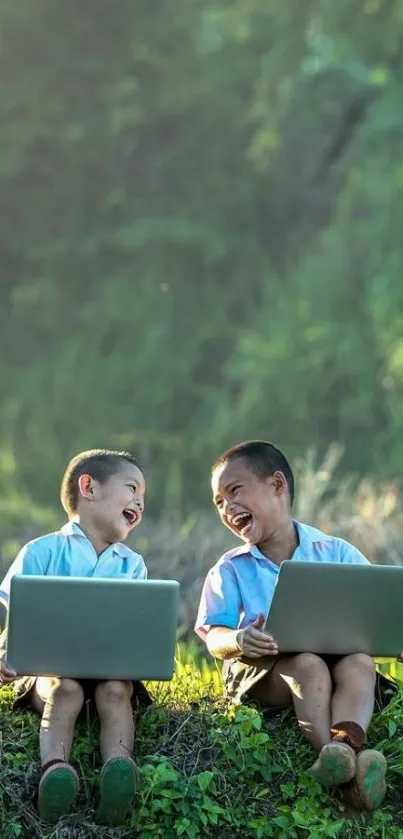 Two children using laptops in a lush green outdoor setting.