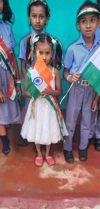 Children in uniform holding Indian flags.