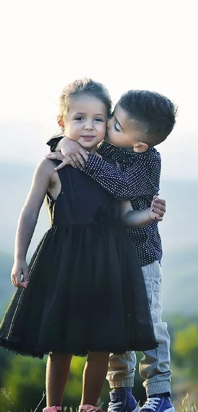 Children hugging with scenic nature view.