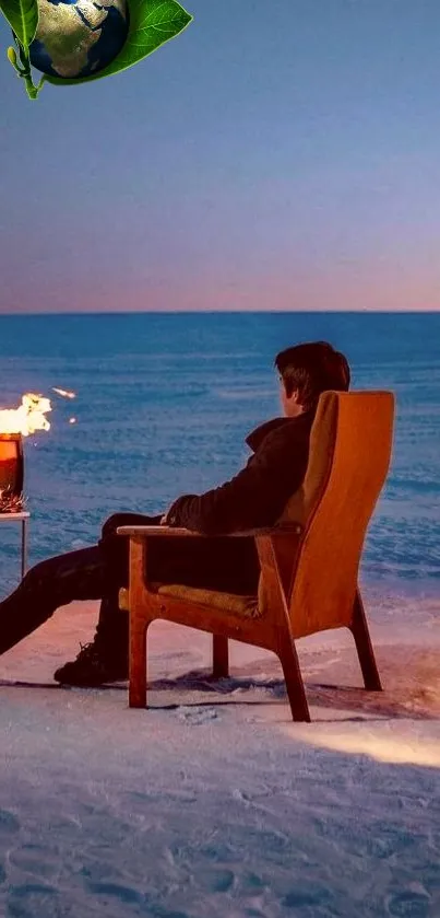 Person relaxing by a fire on a snowy beach at sunset.