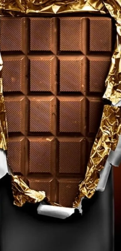 Close-up of a chocolate bar with gold foil wrap.