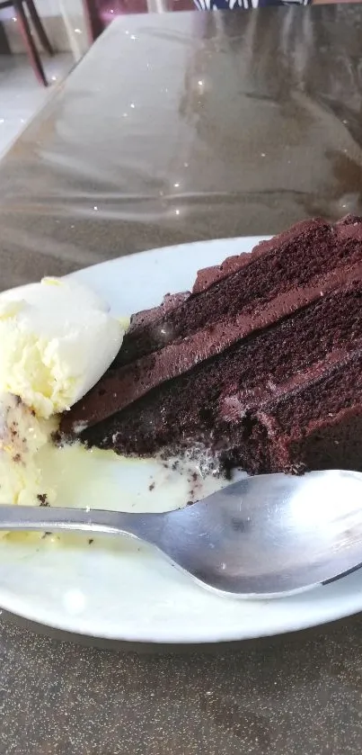 Slice of chocolate cake with ice cream on a plate.