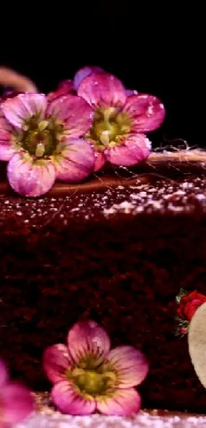 Chocolate cake with pink flowers and heart decor on brown background.